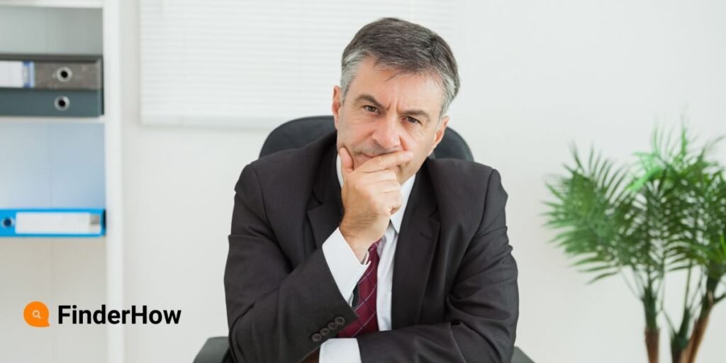 Image of a person sitting at a desk looking thoughtfully